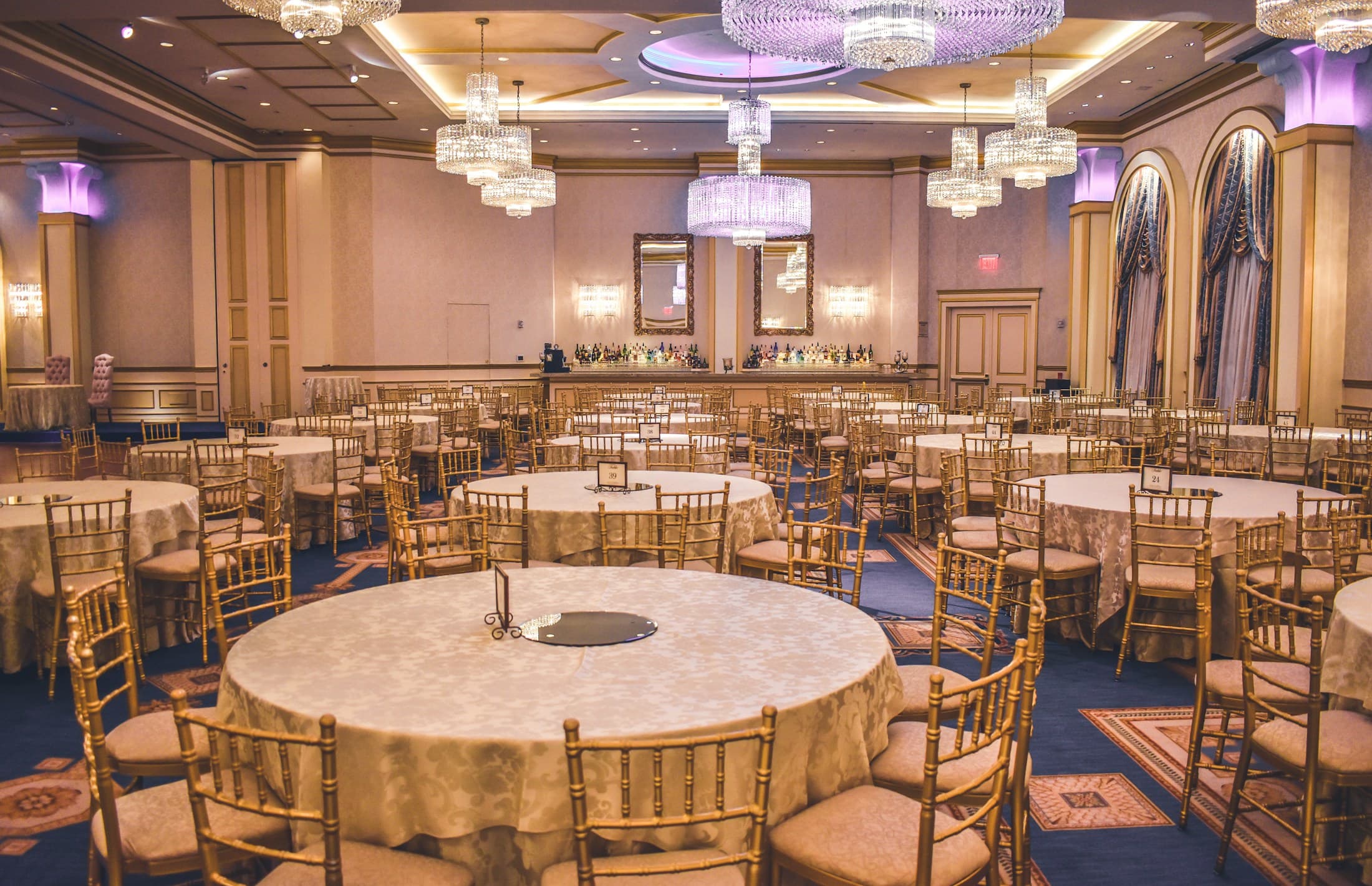 Elegant candlelit event reception with warm ambient lighting and sophisticated table settings